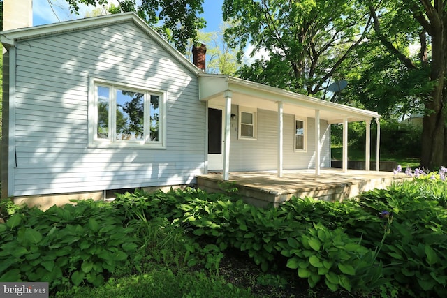 250 E Main St, Millheim, PA 16854 - back of house featuring a chimney and a porch