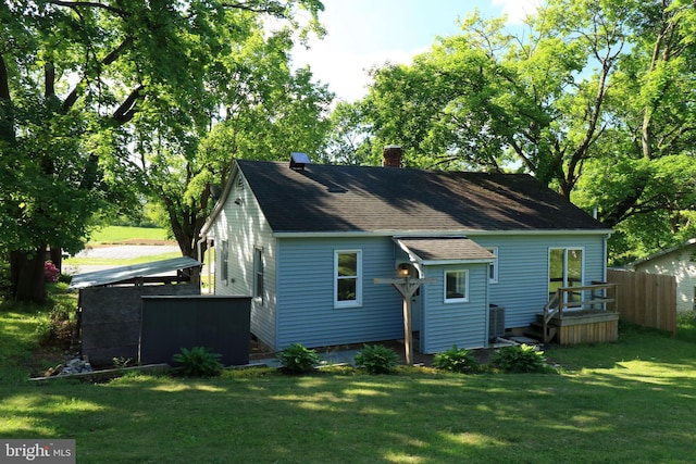 250 E Main St, Millheim, PA 16854 - rear view of house featuring a chimney, roof with shingles, and central AC