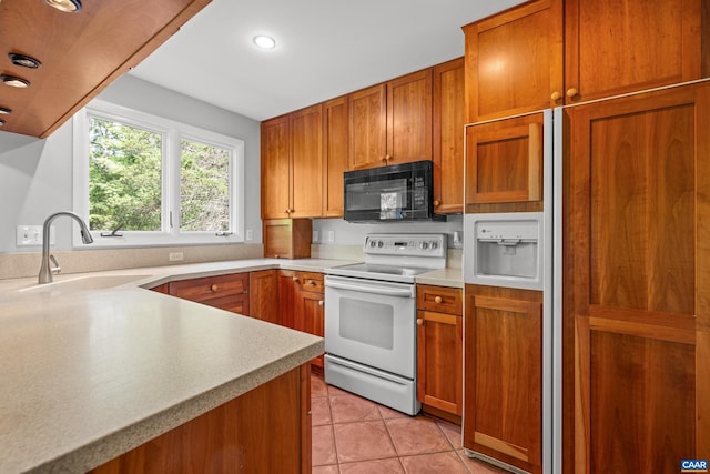 3720 Glenaire Dr, Charlottesville, VA 22901 - kitchen with black microwave, white electric stove, a sink, paneled built in refrigerator, and brown cabinets