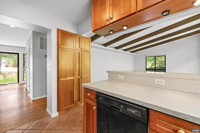 3720 Glenaire Dr, Charlottesville, VA 22901 - kitchen with black dishwasher, light countertops, light tile patterned flooring, baseboards, and brown cabinets