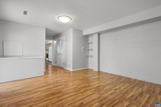 3720 Glenaire Dr, Charlottesville, VA 22901 - spare room featuring light wood-type flooring, baseboards, and concrete block wall