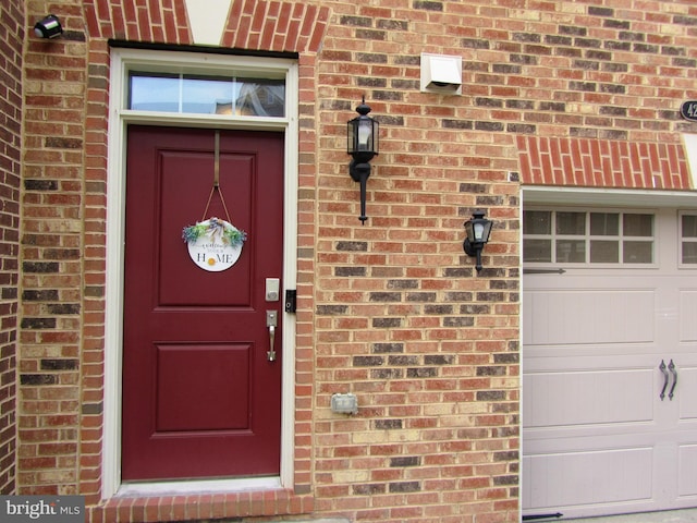 42624 Lisburn Chase Ter, Chantilly, VA 20152 - view of exterior entry with brick siding and a garage