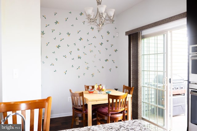 42624 Lisburn Chase Ter, Chantilly, VA 20152 - dining area with a chandelier, baseboards, wood finished floors, and wallpapered walls