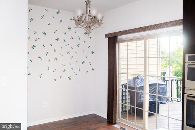 42624 Lisburn Chase Ter, Chantilly, VA 20152 - spare room with wood finished floors, wallpapered walls, baseboards, and a chandelier
