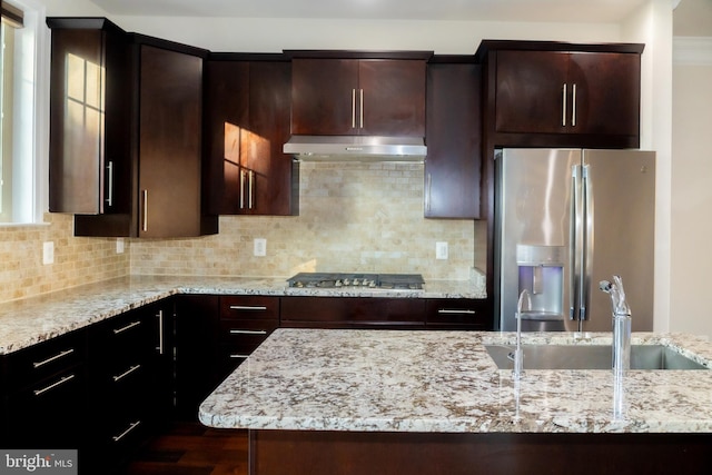 42624 Lisburn Chase Ter, Chantilly, VA 20152 - kitchen featuring stainless steel appliances, under cabinet range hood, light stone counters, and a sink