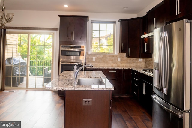 42624 Lisburn Chase Ter, Chantilly, VA 20152 - kitchen with appliances with stainless steel finishes, a sink, dark wood-style flooring, light stone counters, and decorative backsplash