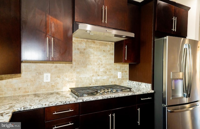 42624 Lisburn Chase Ter, Chantilly, VA 20152 - kitchen featuring stainless steel appliances, under cabinet range hood, backsplash, and light stone counters