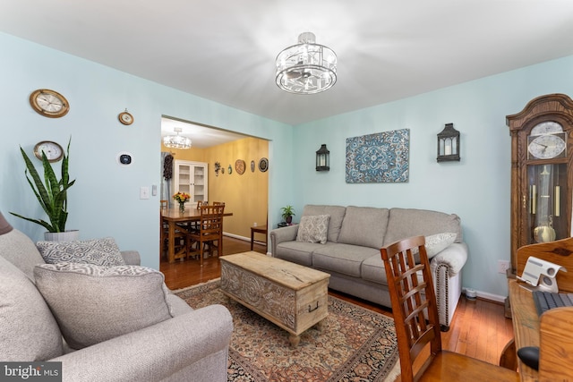 9380 Caucus Dr, King George, VA 22485 - living room featuring a chandelier, wood finished floors, and baseboards