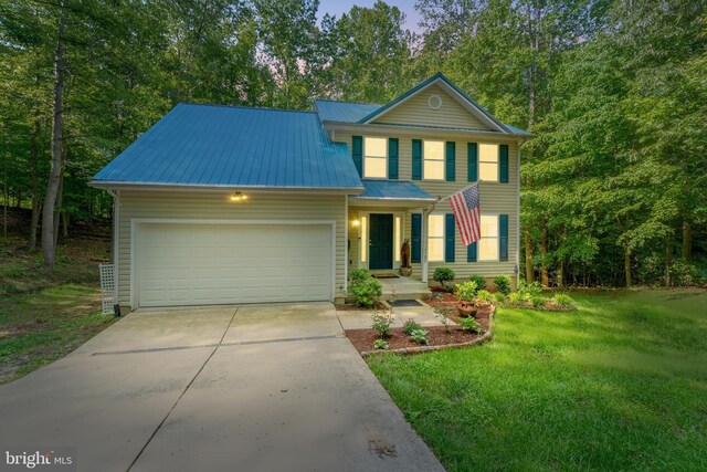 9380 Caucus Dr, King George, VA 22485 - traditional-style house featuring a garage, driveway, metal roof, and a front lawn
