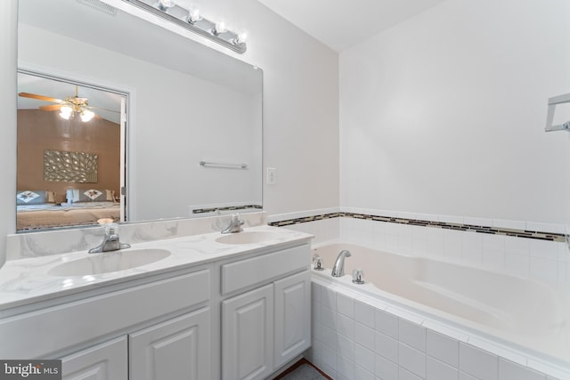 9380 Caucus Dr, King George, VA 22485 - bathroom featuring double vanity, a garden tub, and connected bathroom