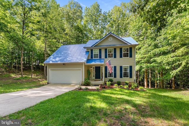 9380 Caucus Dr, King George, VA 22485 - view of front of home with a garage, metal roof, concrete driveway, and a front yard