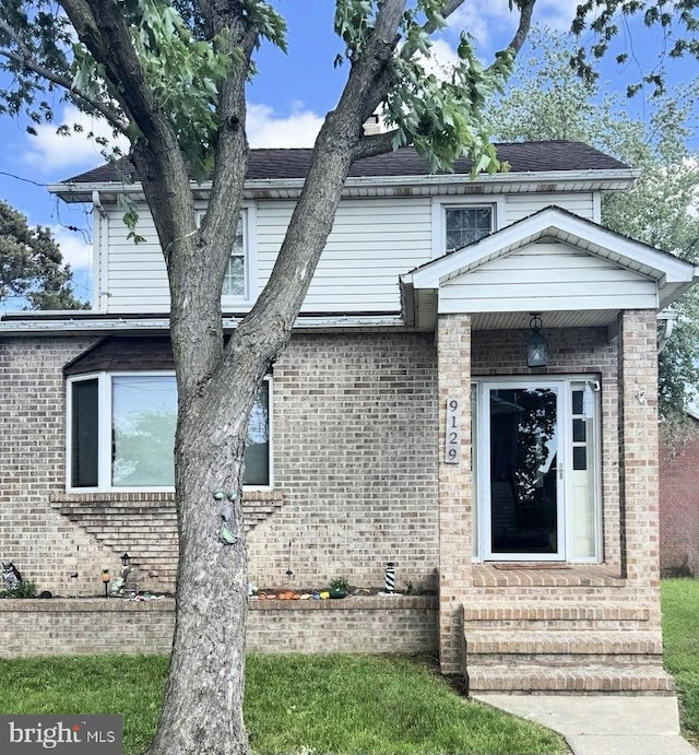 9129 Todd Ave, Fort Howard, MD 21052 - view of front of home featuring entry steps, brick siding, and roof with shingles