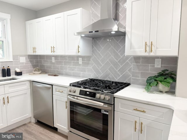 185 La Cascata, Clementon, NJ 08021 - kitchen with wall chimney range hood, stainless steel appliances, white cabinetry, and tasteful backsplash