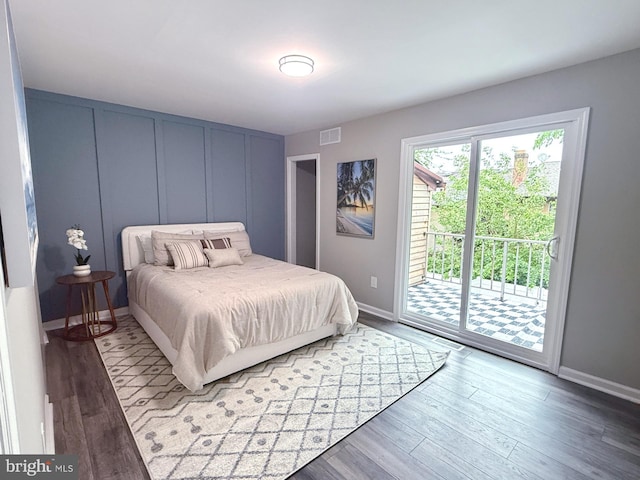 185 La Cascata, Clementon, NJ 08021 - bedroom featuring access to exterior, wood finished floors, a decorative wall, and baseboards