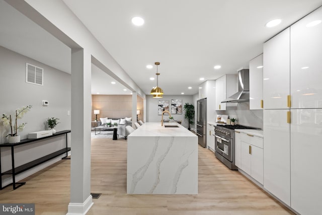 9813 Singleton Dr, Bethesda, MD 20817 - kitchen featuring wall chimney range hood, high end appliances, modern cabinets, white cabinetry, and recessed lighting