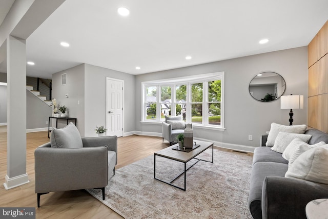 9813 Singleton Dr, Bethesda, MD 20817 - living area featuring stairs, light wood-type flooring, recessed lighting, and baseboards