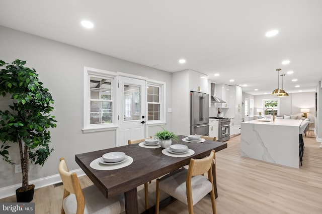 9813 Singleton Dr, Bethesda, MD 20817 - dining space with light wood finished floors, baseboards, and recessed lighting