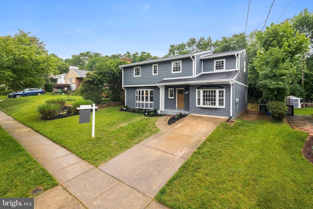 9813 Singleton Dr, Bethesda, MD 20817 - view of front of home featuring concrete driveway, a front lawn, and brick siding