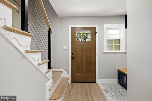 9813 Singleton Dr, Bethesda, MD 20817 - foyer entrance featuring baseboards, light wood-style floors, and stairway
