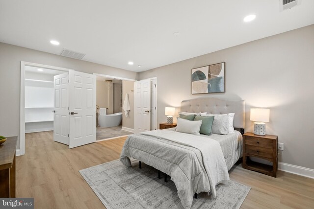 9813 Singleton Dr, Bethesda, MD 20817 - bedroom with light wood-type flooring, a spacious closet, baseboards, recessed lighting, and ensuite bathroom