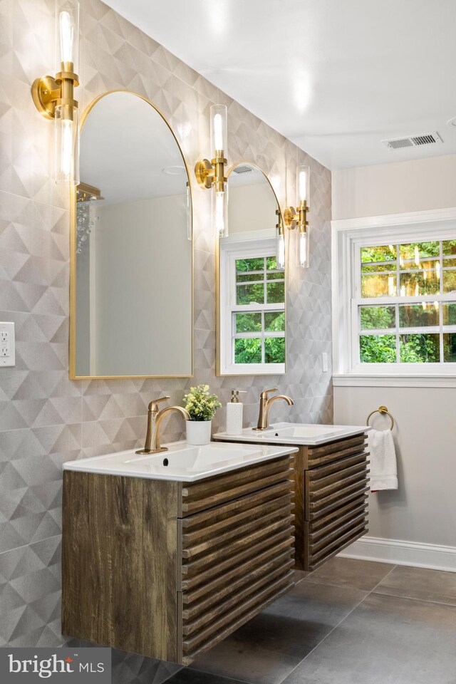 9813 Singleton Dr, Bethesda, MD 20817 - full bath featuring healthy amount of natural light, double vanity, tile walls, baseboards, and tile patterned flooring