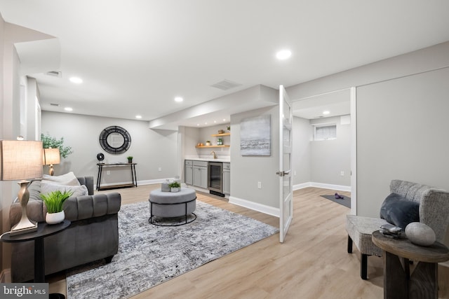 9813 Singleton Dr, Bethesda, MD 20817 - living area with wine cooler, bar, light wood finished floors, recessed lighting, and baseboards