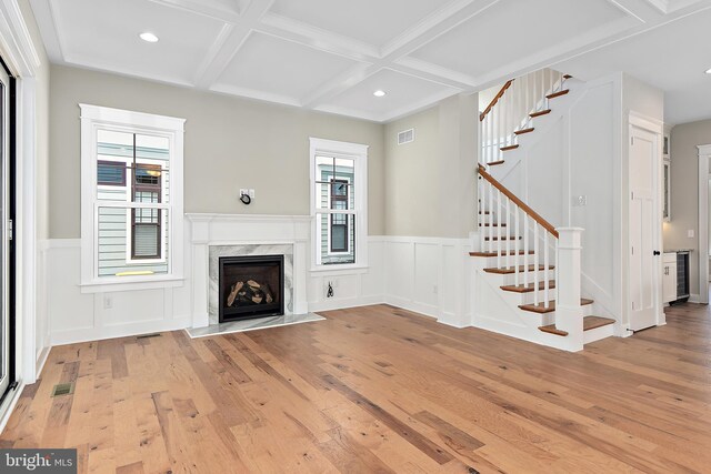 114 Jersey St, Dewey Beach, DE 19971 - unfurnished living room featuring light wood finished floors, coffered ceiling, stairs, beamed ceiling, and a decorative wall
