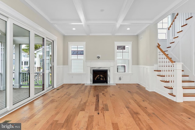 114 Jersey St, Dewey Beach, DE 19971 - unfurnished living room with beam ceiling, coffered ceiling, light wood finished floors, stairs, and a wainscoted wall