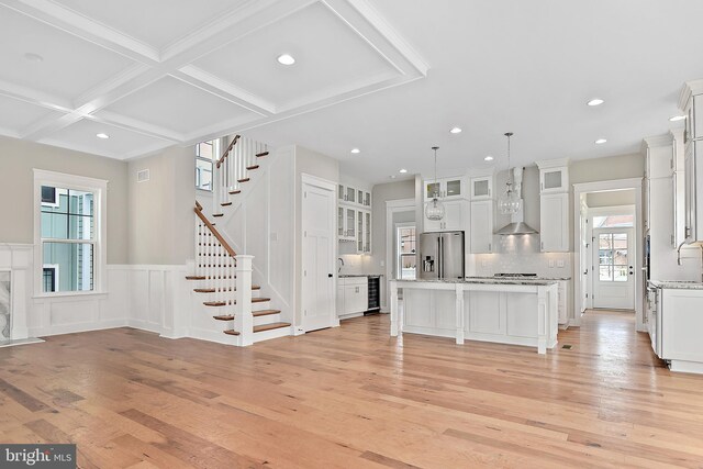 114 Jersey St, Dewey Beach, DE 19971 - kitchen with stainless steel fridge, wall chimney exhaust hood, light wood-type flooring, beamed ceiling, and beverage cooler