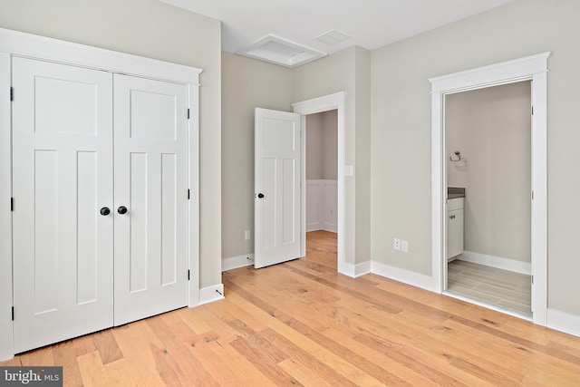 114 Jersey St, Dewey Beach, DE 19971 - unfurnished bedroom with light wood-style floors, baseboards, a closet, and connected bathroom