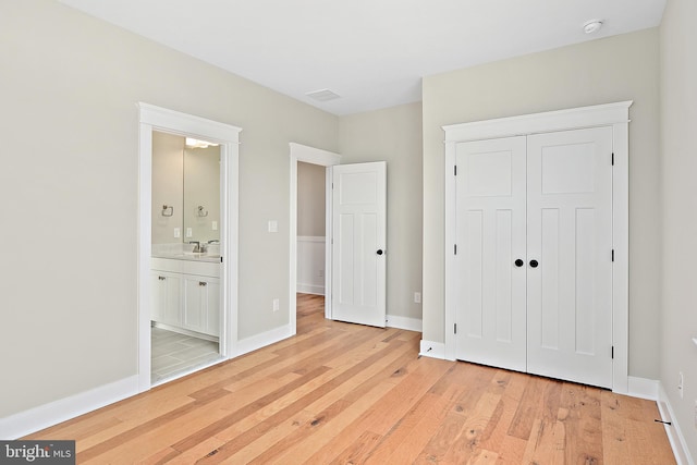114 Jersey St, Dewey Beach, DE 19971 - unfurnished bedroom featuring a sink, light wood finished floors, a closet, and baseboards