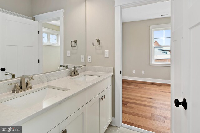 114 Jersey St, Dewey Beach, DE 19971 - bathroom with double vanity, baseboards, and wood finished floors