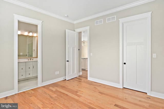 114 Jersey St, Dewey Beach, DE 19971 - unfurnished bedroom with ornamental molding, light wood-type flooring, baseboards, a sink, and connected bathroom