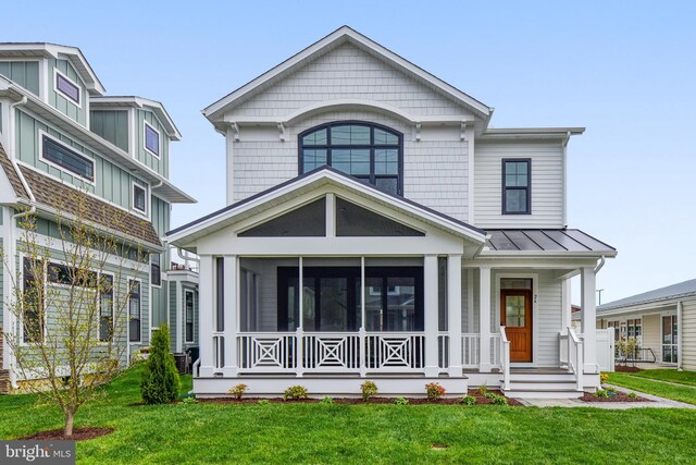 114 Jersey St, Dewey Beach, DE 19971 - view of front of home featuring a front yard, a standing seam roof, and a sunroom