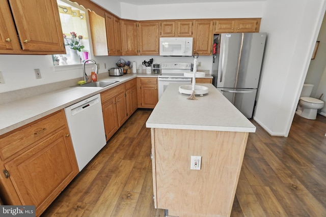 134 Cobblestone Dr, Gilbertsville, PA 19525 - kitchen featuring white appliances, a sink, a center island, light countertops, and dark wood-style flooring