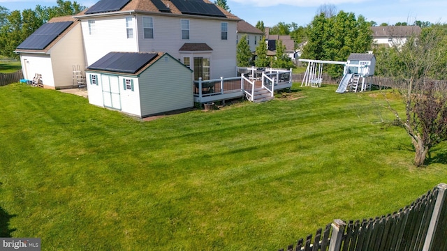 134 Cobblestone Dr, Gilbertsville, PA 19525 - back of property featuring a playground, solar panels, and a wooden deck