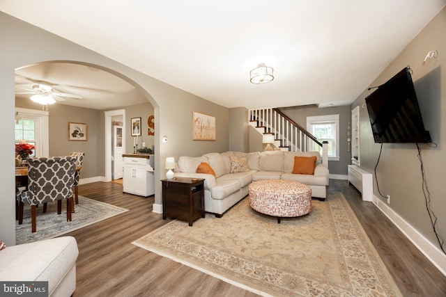 951 Little Conestoga Rd, Glenmoore, PA 19343 - living room with dark wood-style floors, arched walkways, stairs, and baseboards