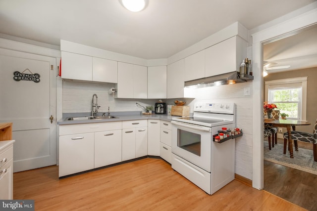 951 Little Conestoga Rd, Glenmoore, PA 19343 - kitchen with white range with electric cooktop, a sink, white cabinetry, light wood-type flooring, and tasteful backsplash