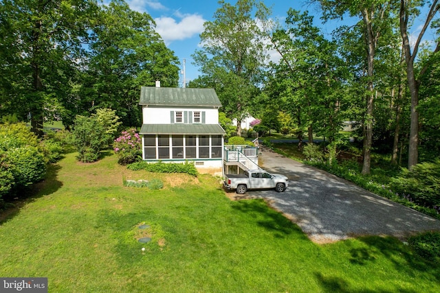 951 Little Conestoga Rd, Glenmoore, PA 19343 - back of house featuring a sunroom, a lawn, metal roof, stairs, and a chimney