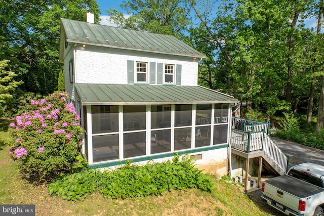 951 Little Conestoga Rd, Glenmoore, PA 19343 - view of side of property featuring a standing seam roof, a sunroom, metal roof, stairway, and a chimney