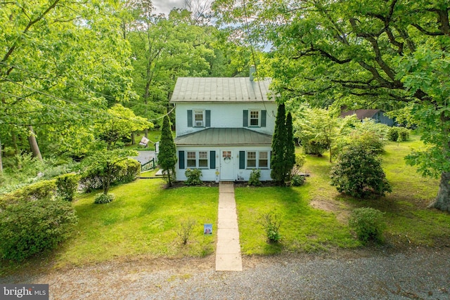 951 Little Conestoga Rd, Glenmoore, PA 19343 - view of front of home with metal roof, a front yard, a standing seam roof, and a forest view