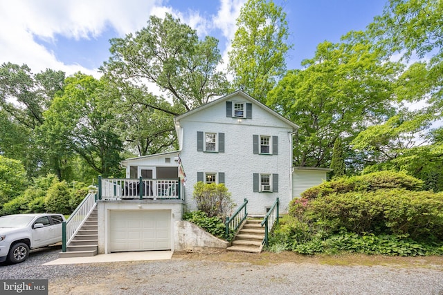 951 Little Conestoga Rd, Glenmoore, PA 19343 - view of front of house featuring stairway, dirt driveway, a wooden deck, view of scattered trees, and an attached garage