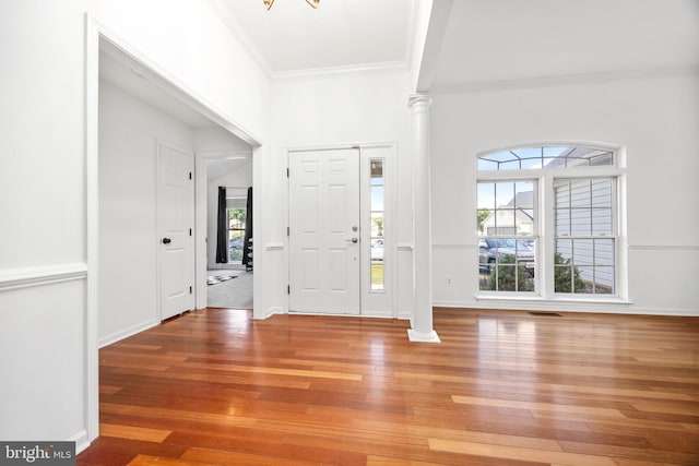 9177 Drawbridge Dr, Delmar, MD 21875 - entrance foyer featuring decorative columns, crown molding, light wood-style flooring, and baseboards
