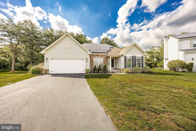 9177 Drawbridge Dr, Delmar, MD 21875 - ranch-style house with asphalt driveway, roof mounted solar panels, a front lawn, an attached garage, and brick siding