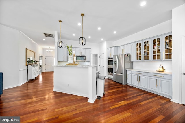 9177 Drawbridge Dr, Delmar, MD 21875 - kitchen featuring appliances with stainless steel finishes, glass insert cabinets, dark wood-type flooring, a peninsula, and recessed lighting