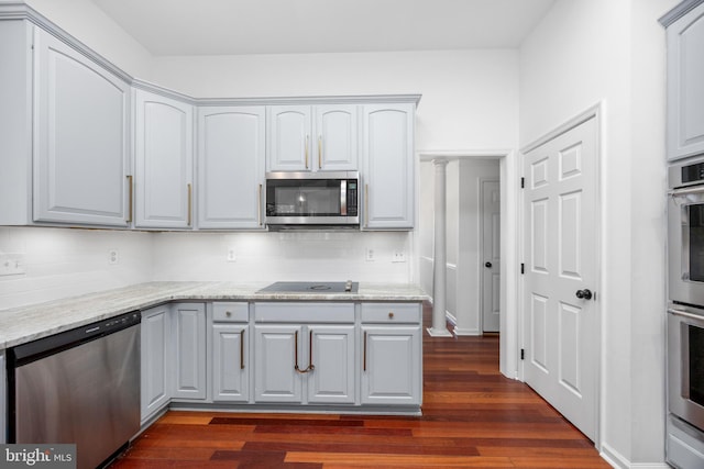 9177 Drawbridge Dr, Delmar, MD 21875 - kitchen with stainless steel appliances, decorative backsplash, dark wood-style flooring, and gray cabinets