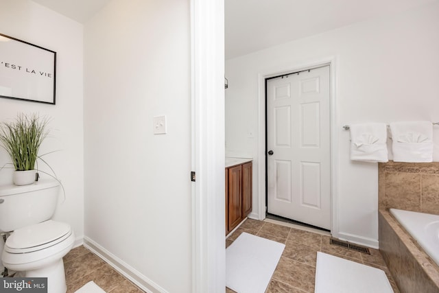 9177 Drawbridge Dr, Delmar, MD 21875 - bathroom with toilet, tiled bath, tile patterned floors, baseboards, and vanity