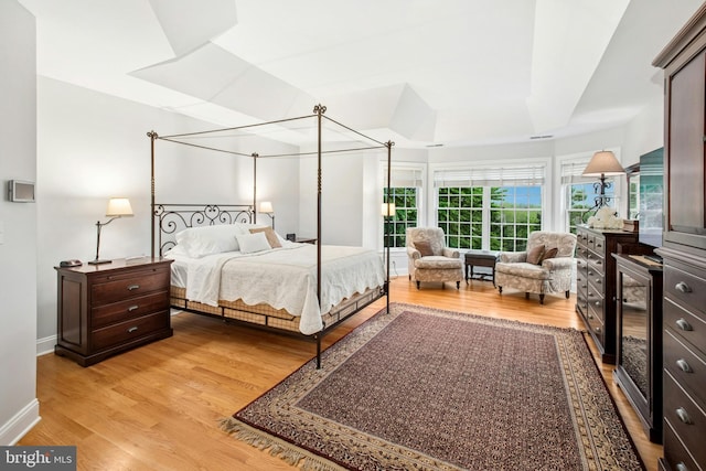 bedroom with light wood-style floors and baseboards