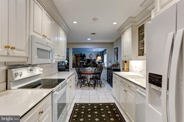 10 Devonshire Sq, Mechanicsburg, PA 17050 - kitchen featuring white appliances, light tile patterned floors, light countertops, crown molding, and recessed lighting