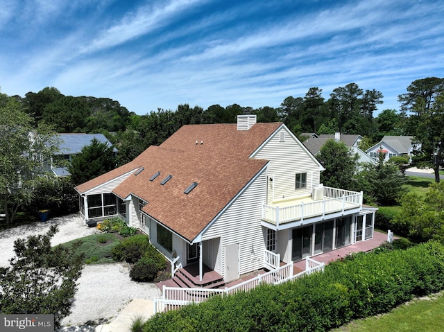957 Terrapin St Unit 2, Bethany Beach, DE 19930 - rear view of house featuring a sunroom, a balcony, a shingled roof, and view of wooded area
